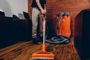 water damage restoration technician extracting water from office