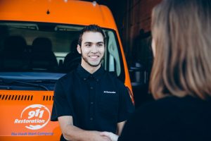 commercial restoration technician talking to customer